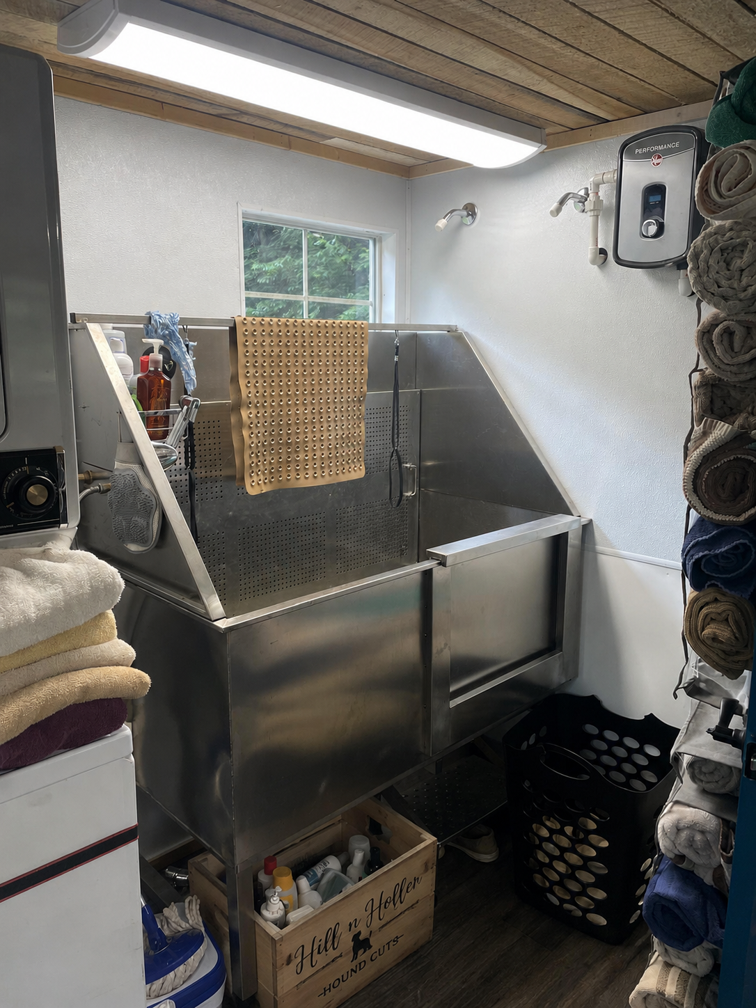 Stainless steel grooming tub at Hill N Holler Hound Cuts